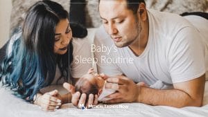 Sleeping baby with parents on bed