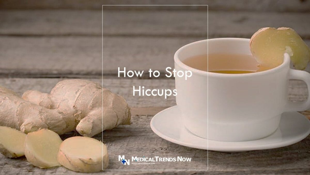 a hot cup of ginger root tea with raw ginger