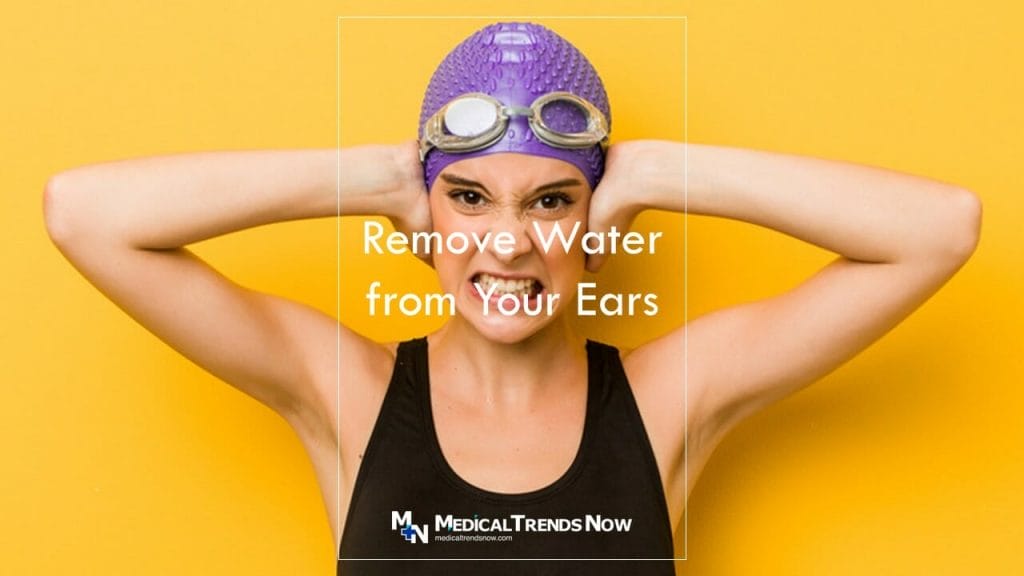 removing water from your ears after swimming