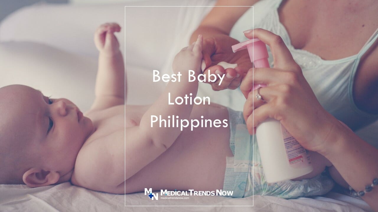 A Filipina mother holding baby lotion to soften the skin of her infant