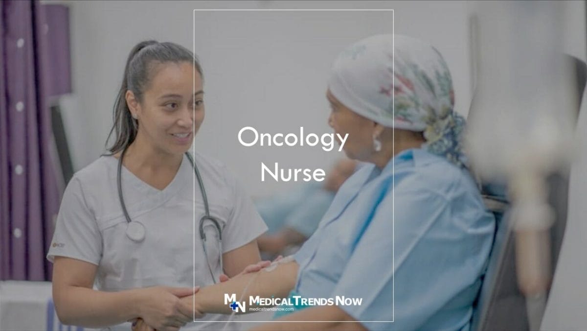 a female nurse talking to a cancer patient at the hospital room