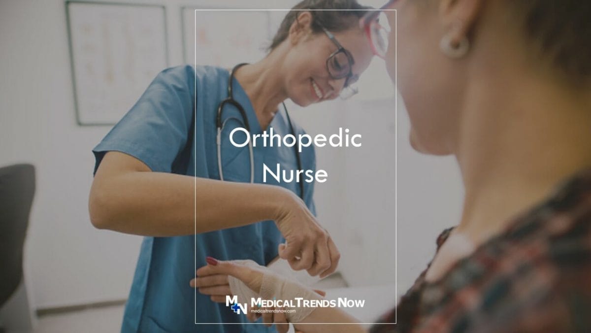 a nurse removing a plaster bandage from a patient's wrist